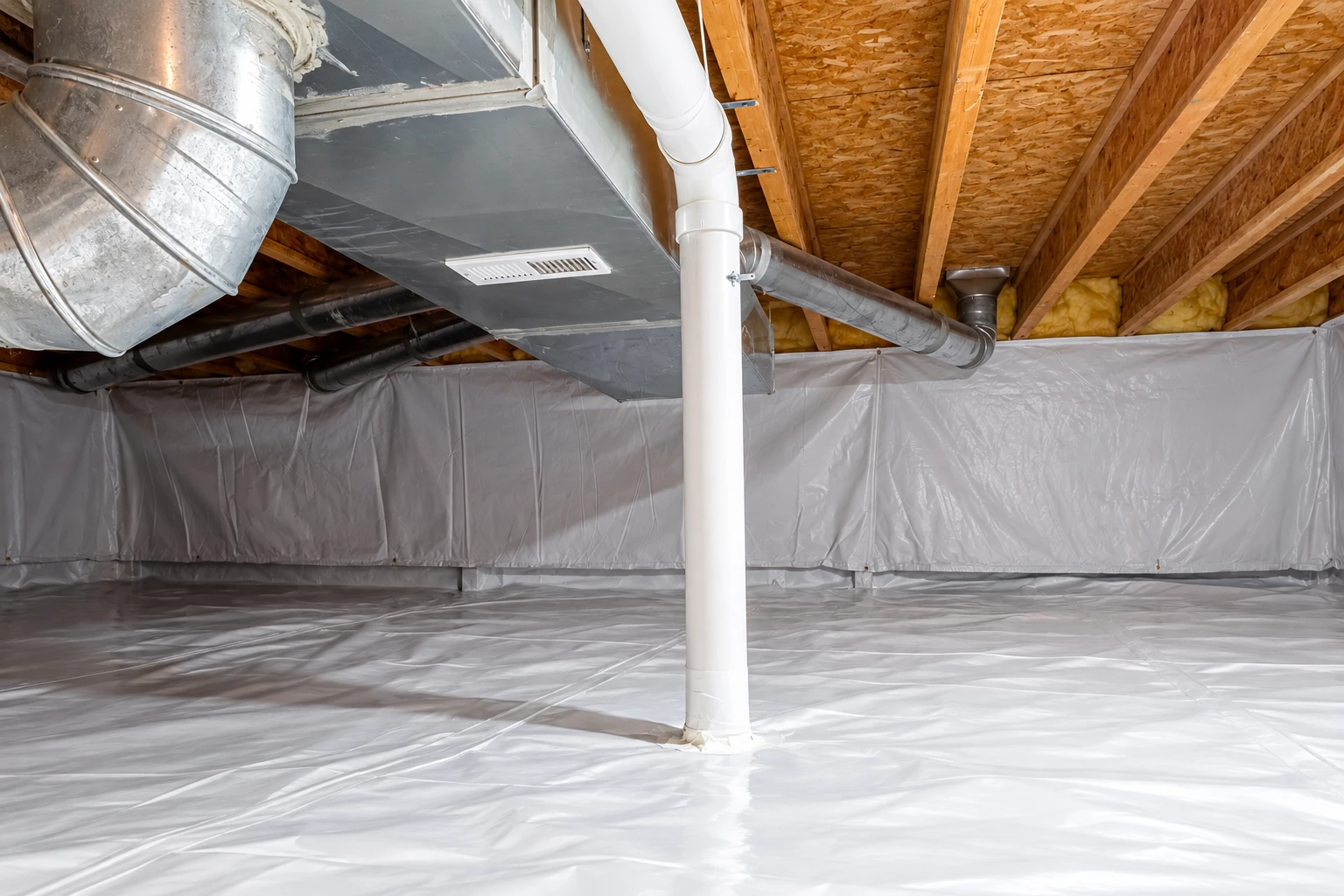A white vapor barrier lines the floor and walls of a crawl space around a support pipe and HVAC ducts.